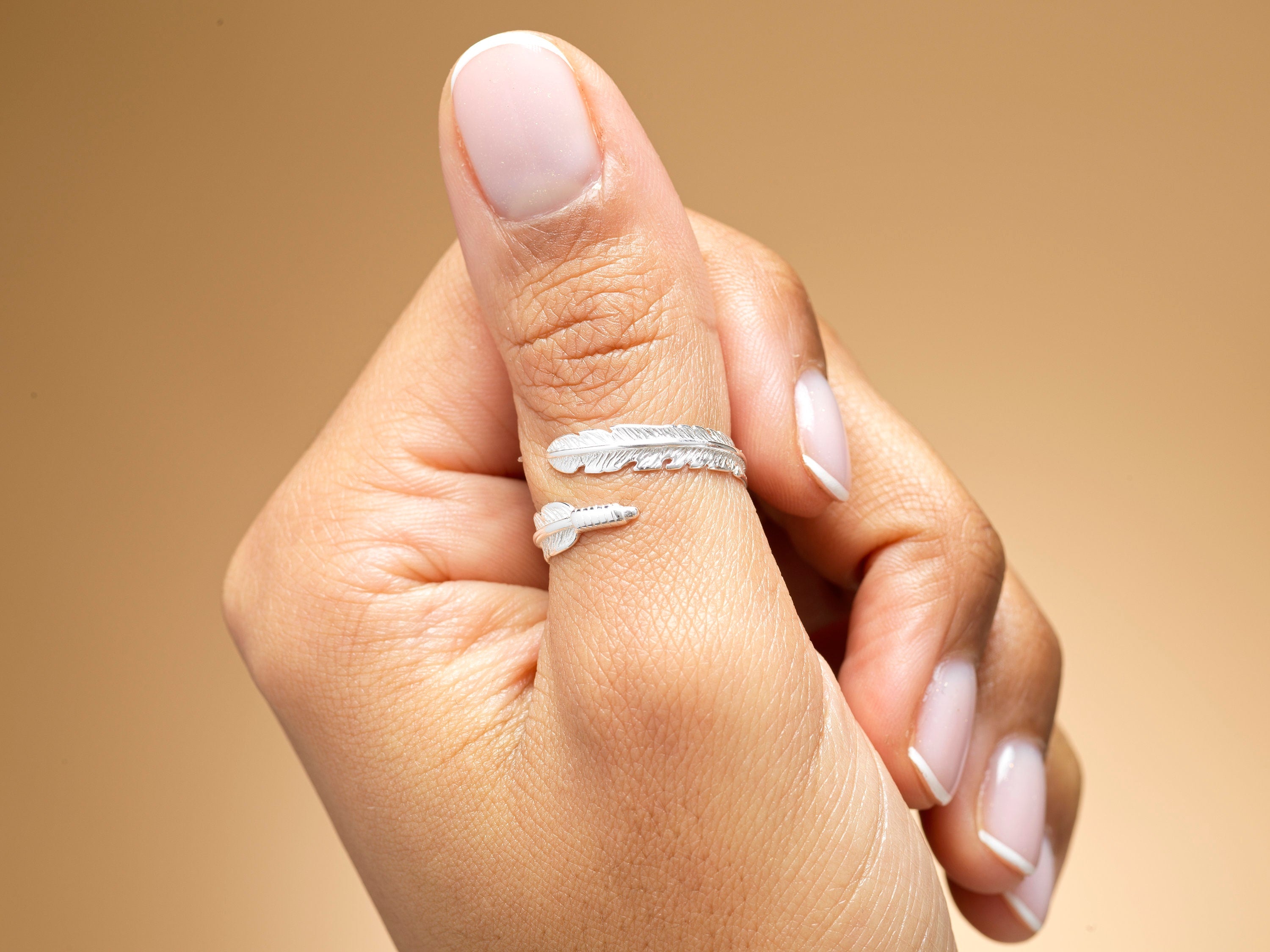 A model wearing a sterling silver feather wrap ring.