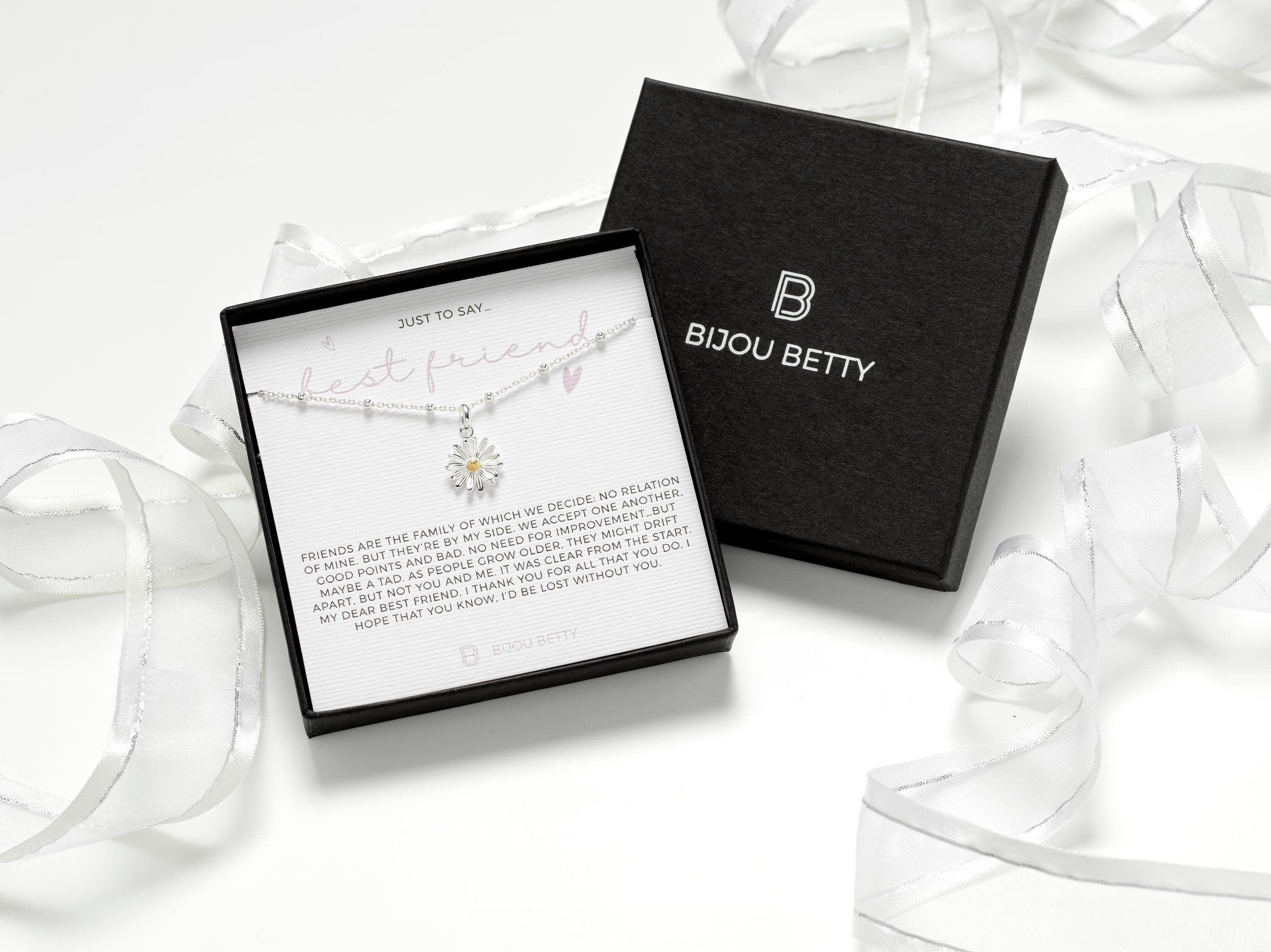 Sterling silver daisy necklace, perfect gift for best friend. Features delicate design symbolising friendship and joy. Includes gift box, bag, tissue, and card for a meaningful presentation.