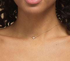 Close up of model wearing Bijou Betty’s 925 silver heart necklace, 9mm x 8mm heart pendant, silver or gold plate, on 16–18 inch chain, styled elegantly.