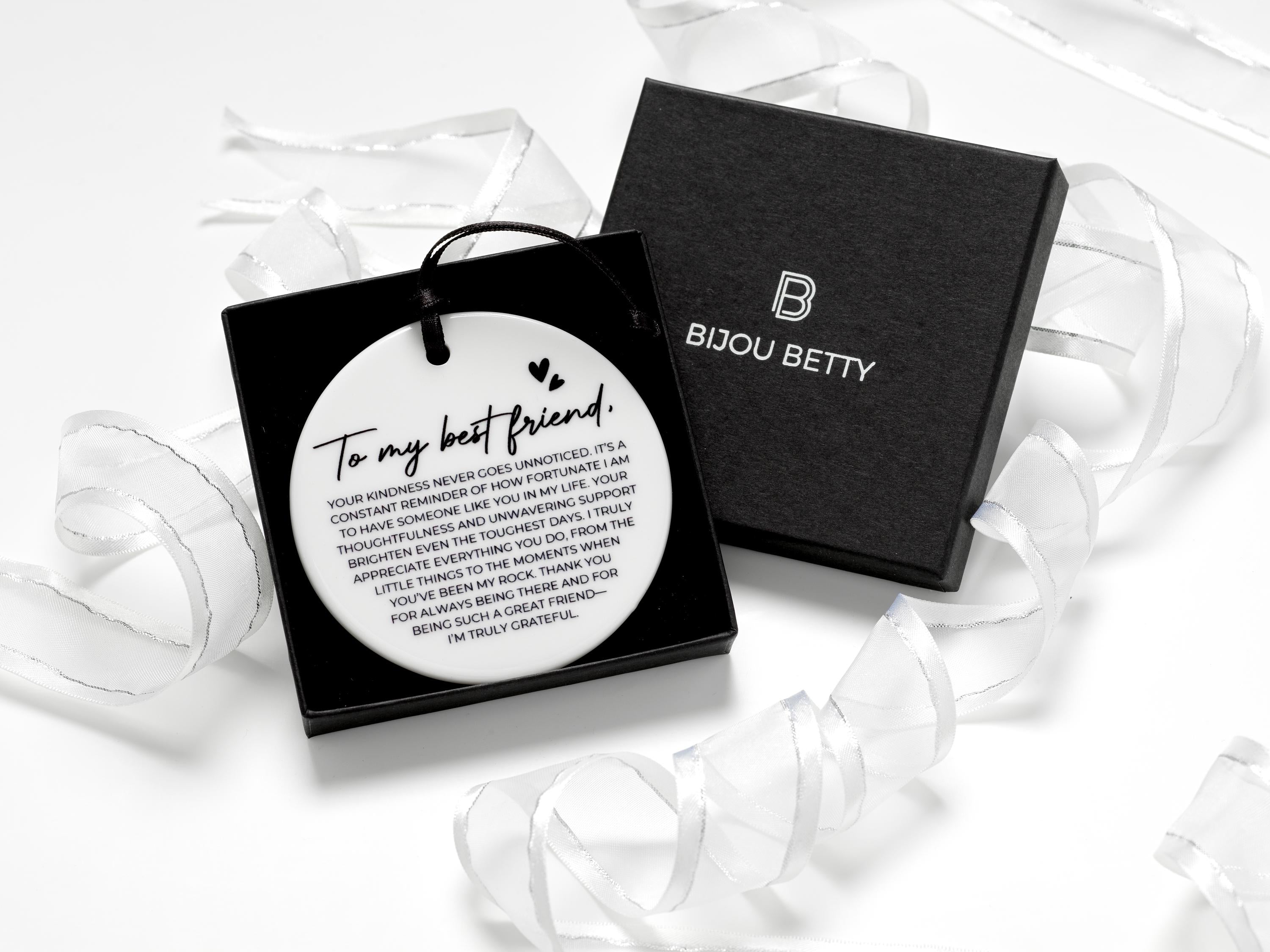 Ceramic round friendship gift (75mm diameter) with best friend quote and black satin ribbon, wrapped in tissue paper, optional gift box or bag.