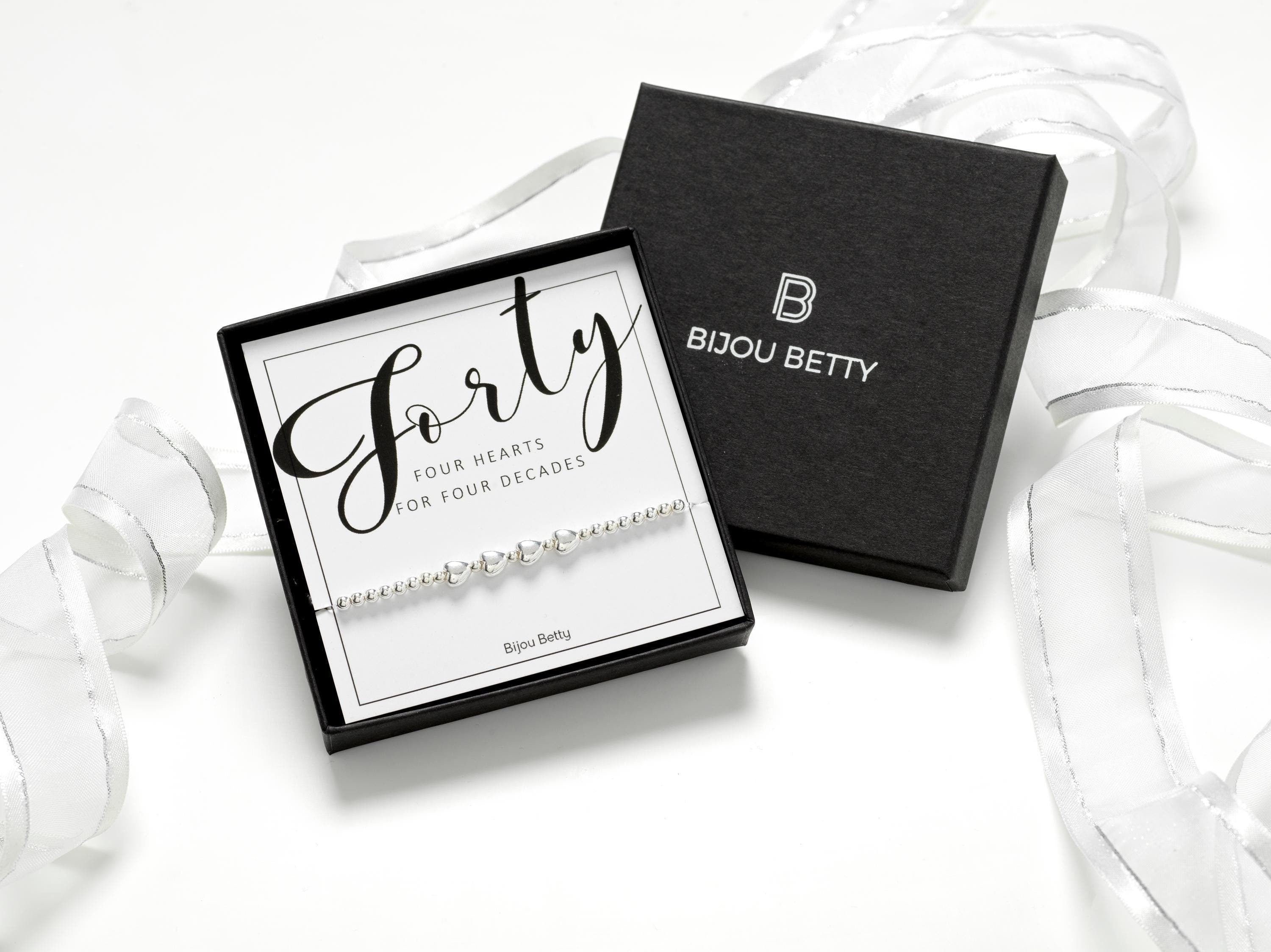 Sterling silver 40th birthday bracelet gift, 4 heart charms, stretch fit, in Bijou Betty gift box with bag and card.