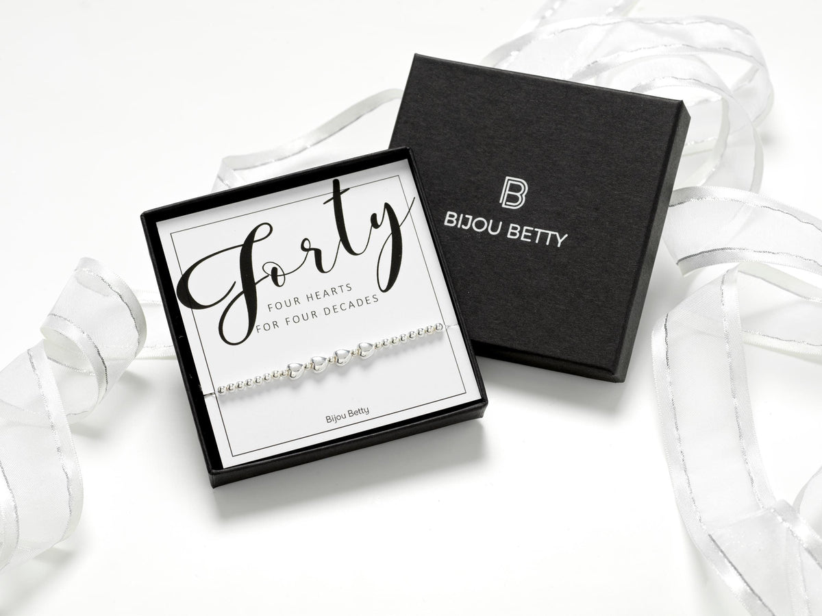 Sterling silver 40th birthday bracelet gift, 4 heart charms, stretch fit, in Bijou Betty gift box with bag and card.