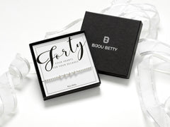 Sterling silver 40th birthday bracelet gift, 4 heart charms, stretch fit, in Bijou Betty gift box with bag and card.