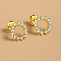 Close-up of Bijou Betty’s 925 silver sunburst stud earrings, 10mm with cubic zirconia with gold plate.