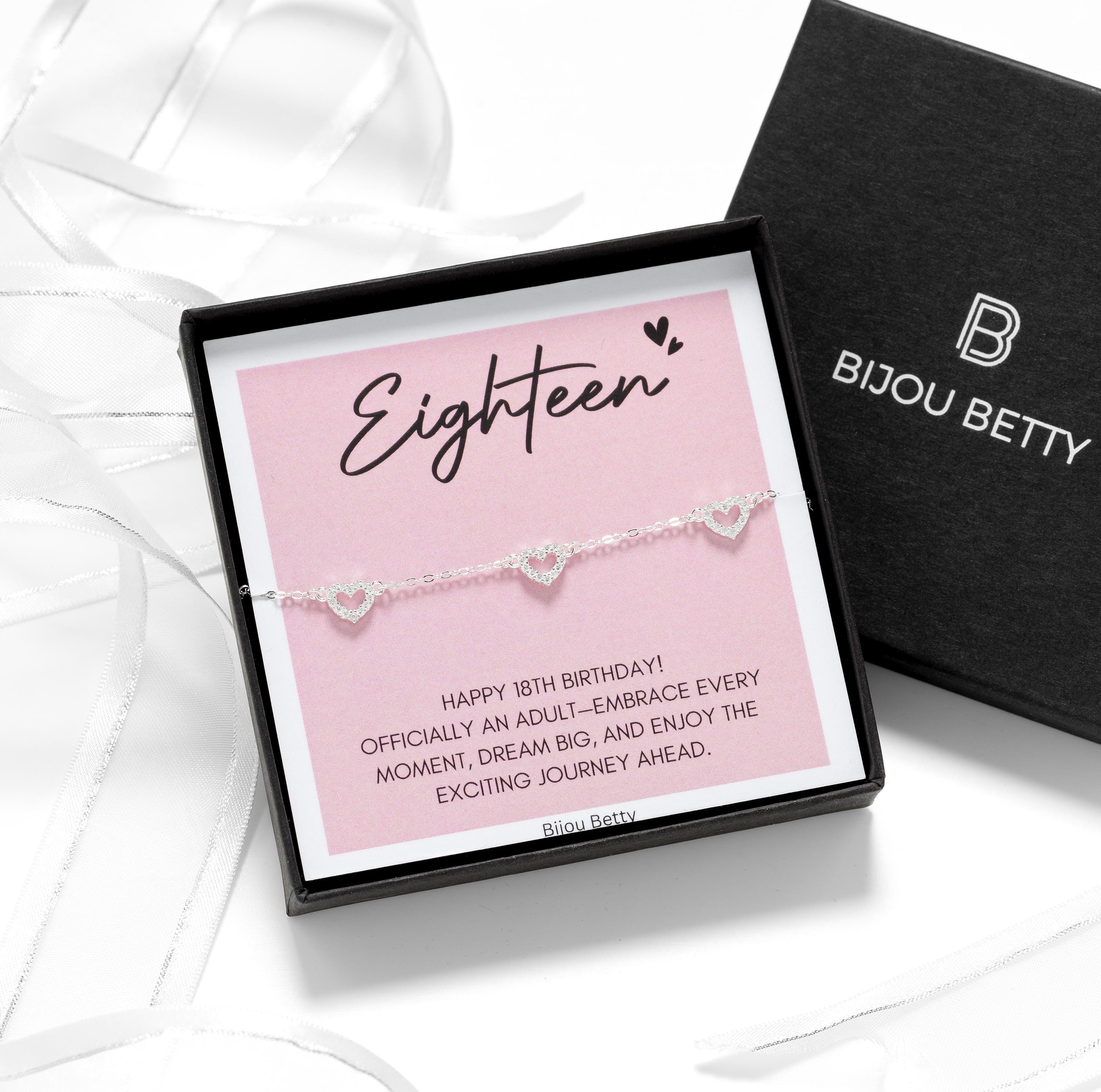 Close up of Bijou Betty’s 18th birthday gift set, 925 silver heart bracelet in gift box, tissue, and card: Eighteen - Happy 18th Birthday!