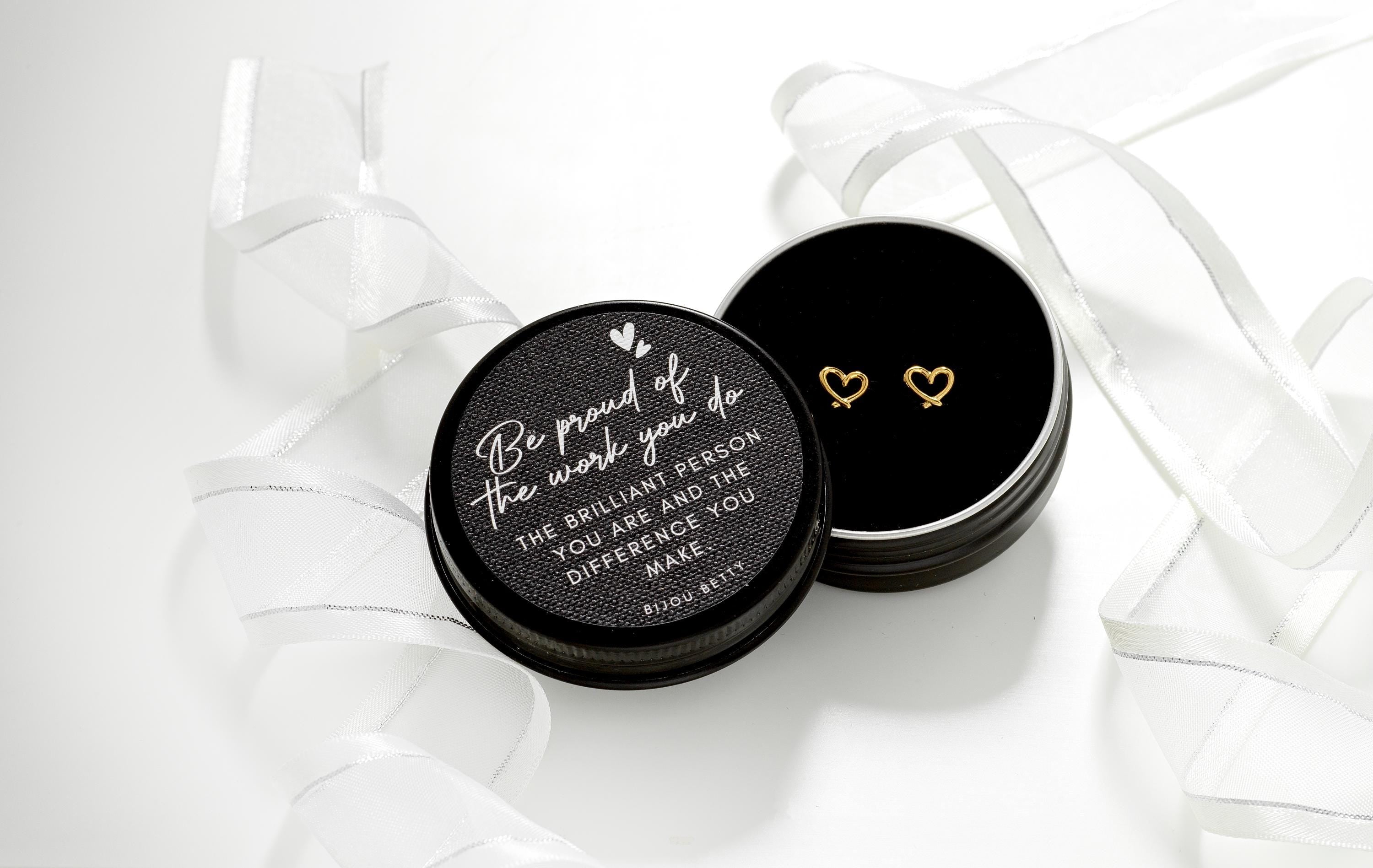 Gold-plated stainless steel 7mm heart stud earrings, presented in a Bijou Betty gift box featuring the “Be Proud” quote, making them an ideal gift for daughters.