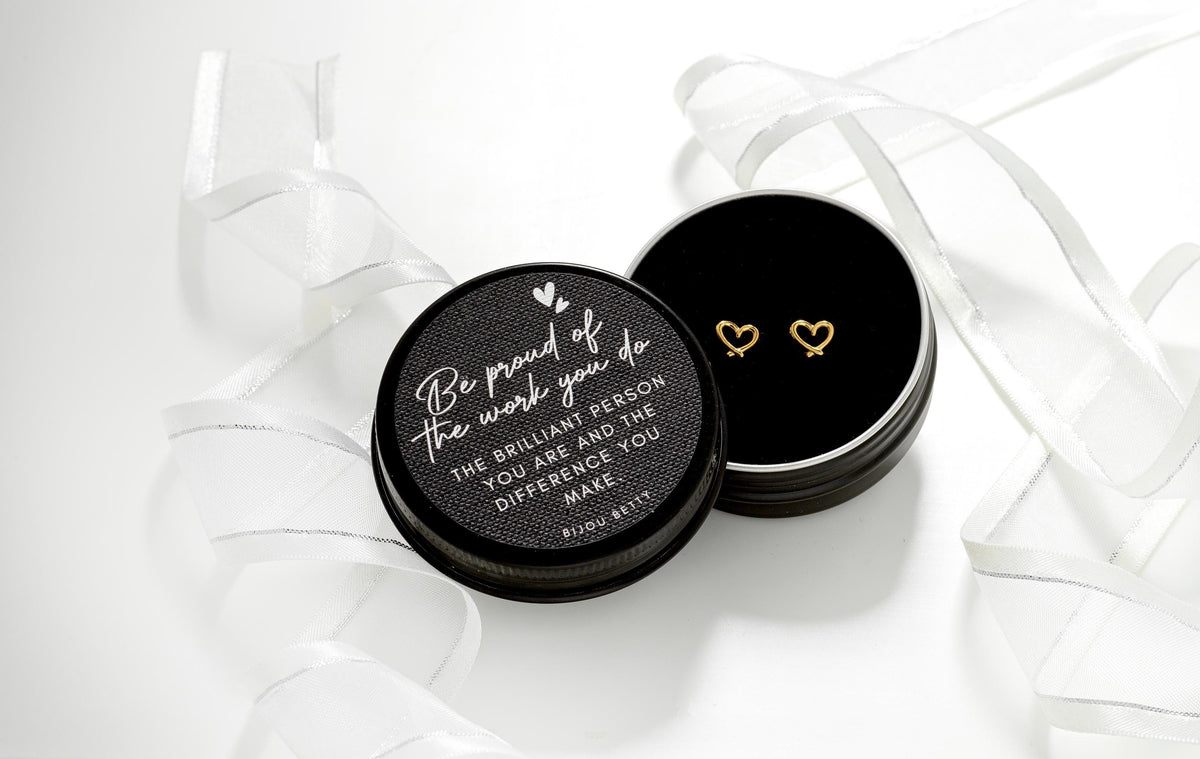 Gold-plated stainless steel 7mm heart stud earrings, presented in a Bijou Betty gift box featuring the “Be Proud” quote, making them an ideal gift for daughters.