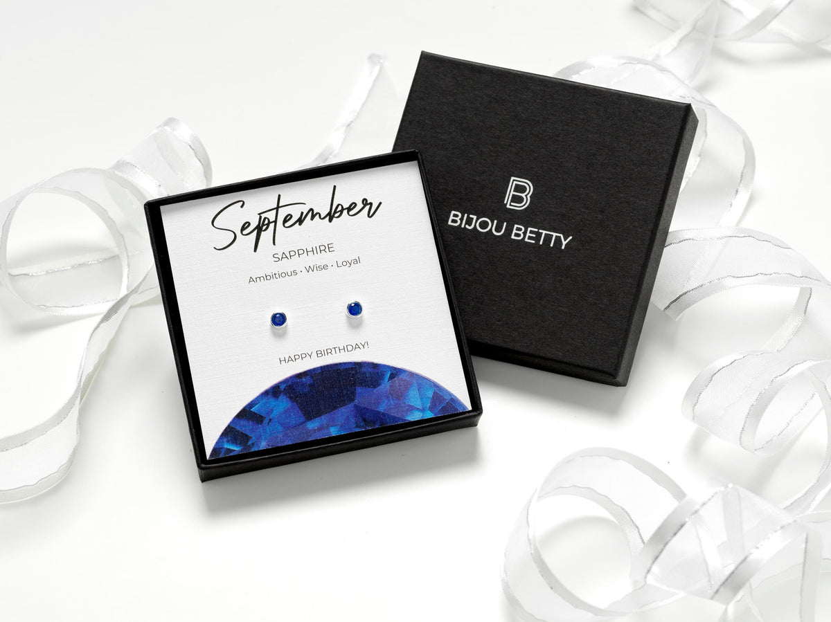 Sterling silver 4mm sapphire-style CZ stud earrings in Bijou Betty gift box with September birthstone card.