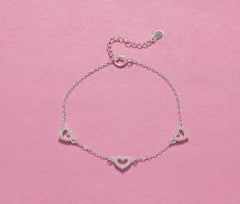 Close-up of 925 silver bracelet with three CZ hearts, perfect for 21st birthday gifts for sisters or friends.