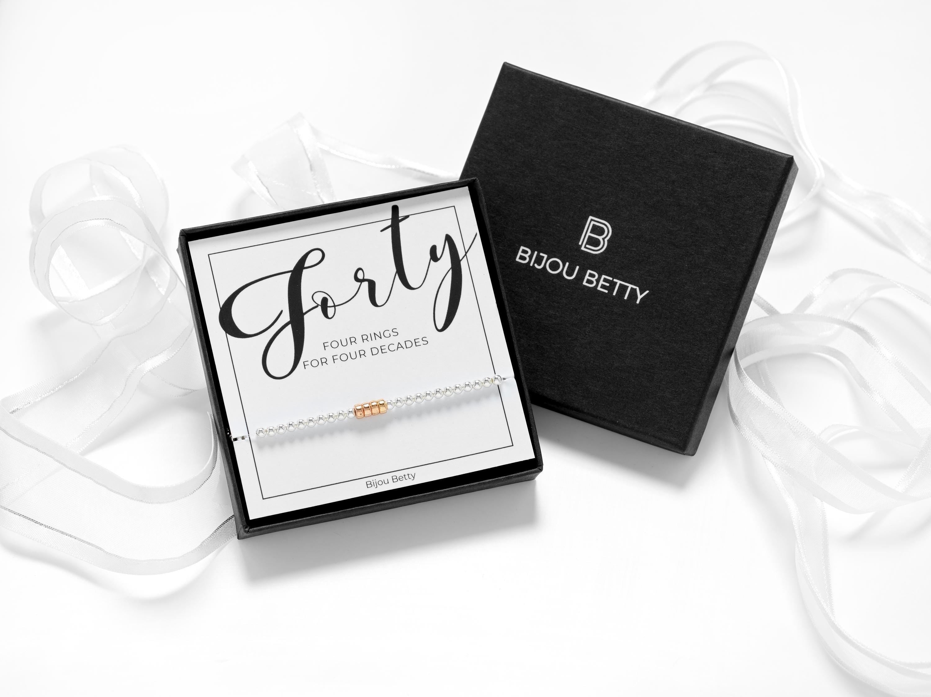 Bijou Betty’s decades bracelet gift set, 925 silver and rose gold rings, in gift box with bag, tissue, and card: “Forty - 4 rings for 4 decades.