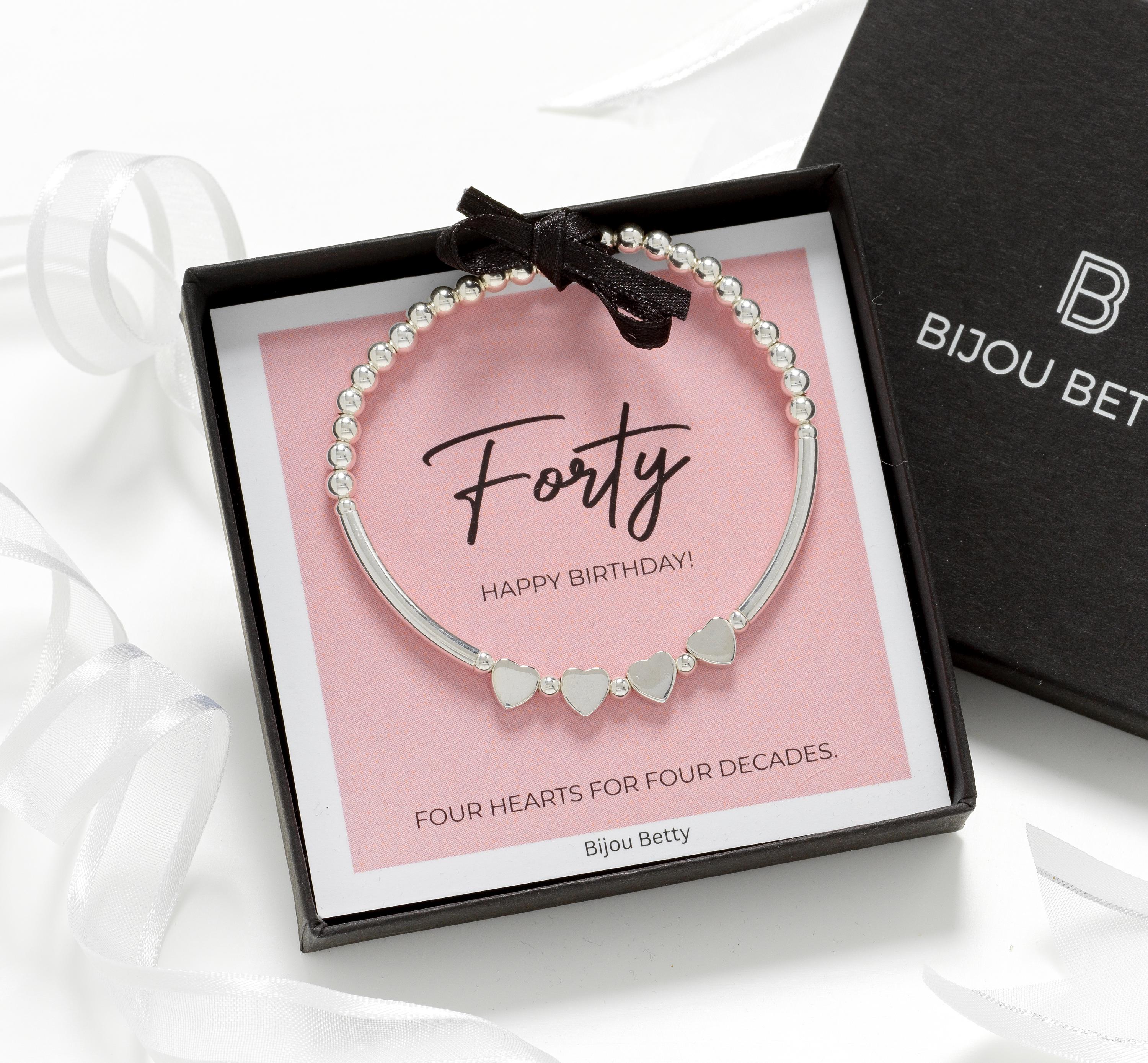 Close-up of Bijou Betty’s 925 silver 40th birthday bracelet with four heart beads, stretch-fit, on white background.