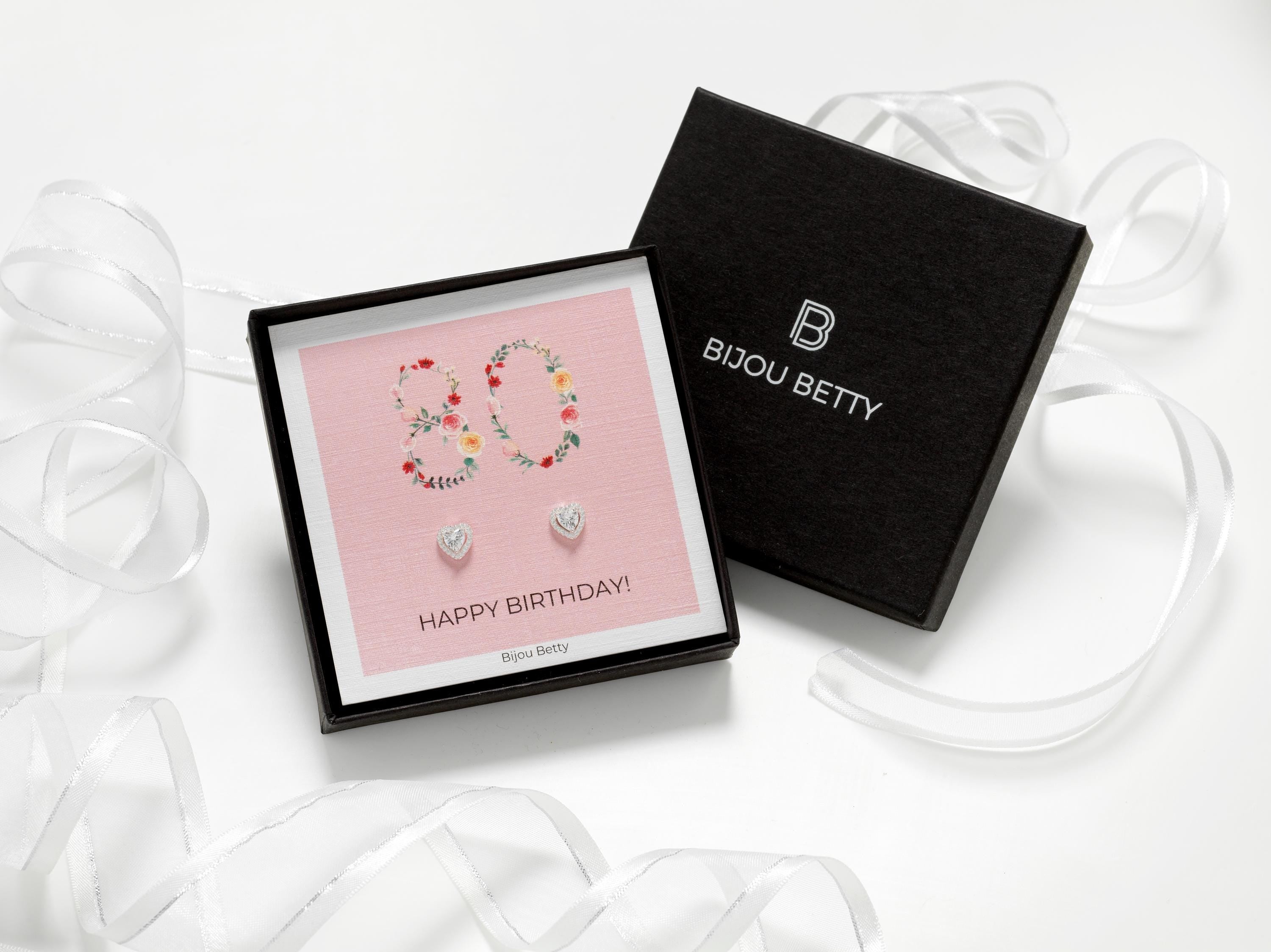 Close up of Bijou Betty’s 80th birthday gift set, 925 silver heart studs in gift box with bag, tissue, and card, 80 Happy Birthday!