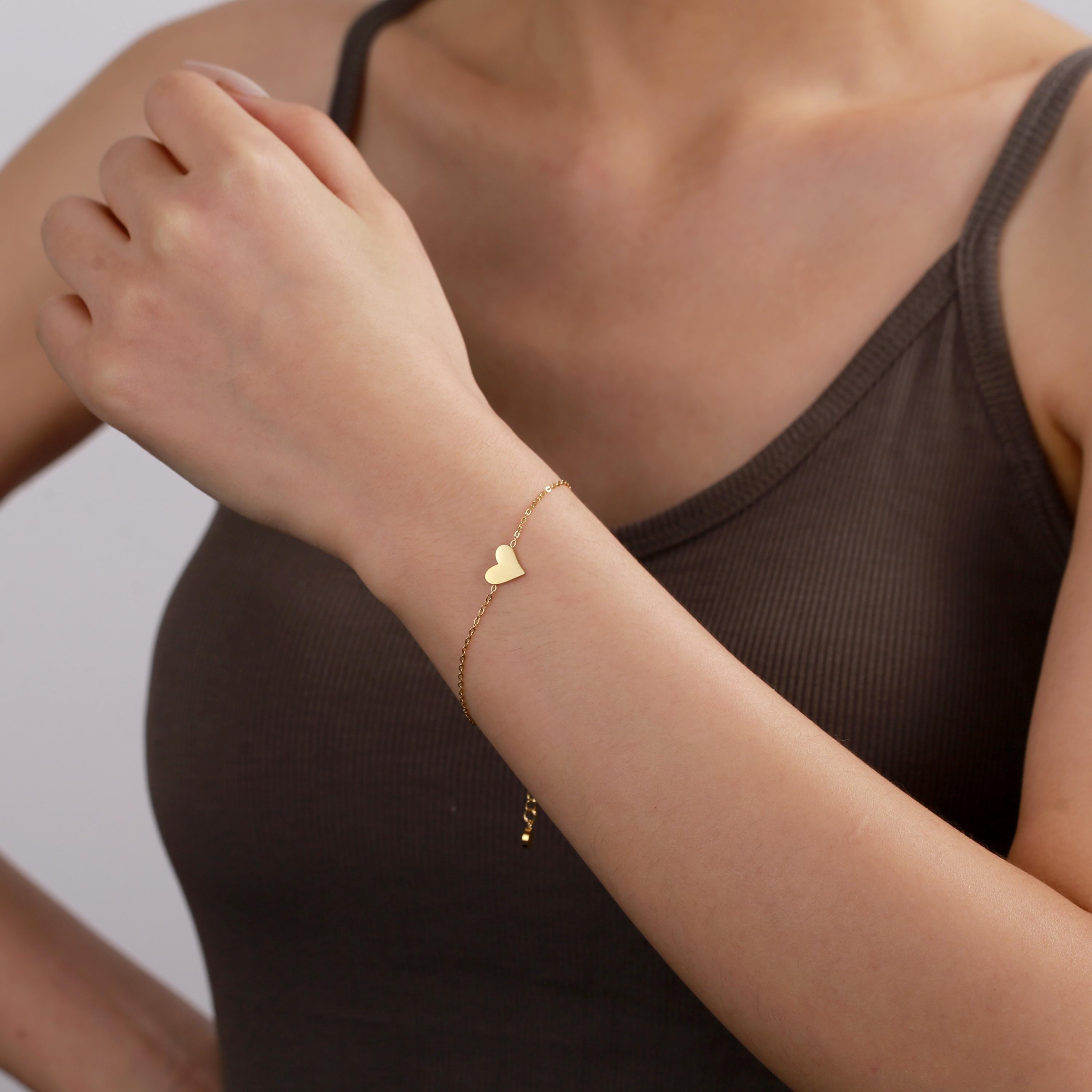 Close-up of gold-plated stainless steel heart bracelet, perfect for thank you gifts for colleagues.