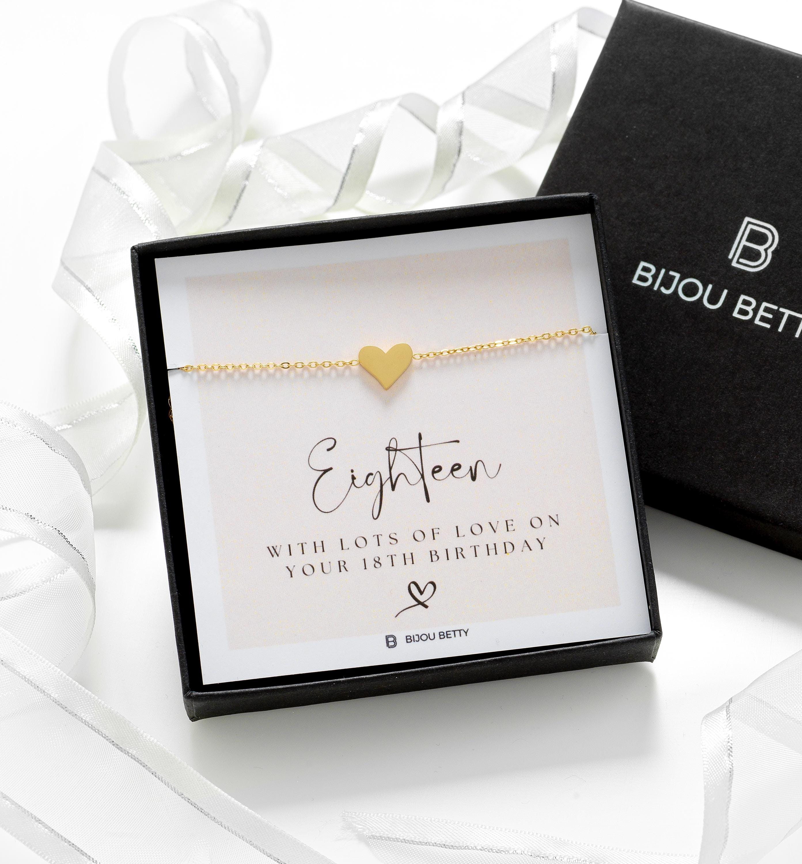 Close up of an 18th birthday heart bracelet with gold plating.