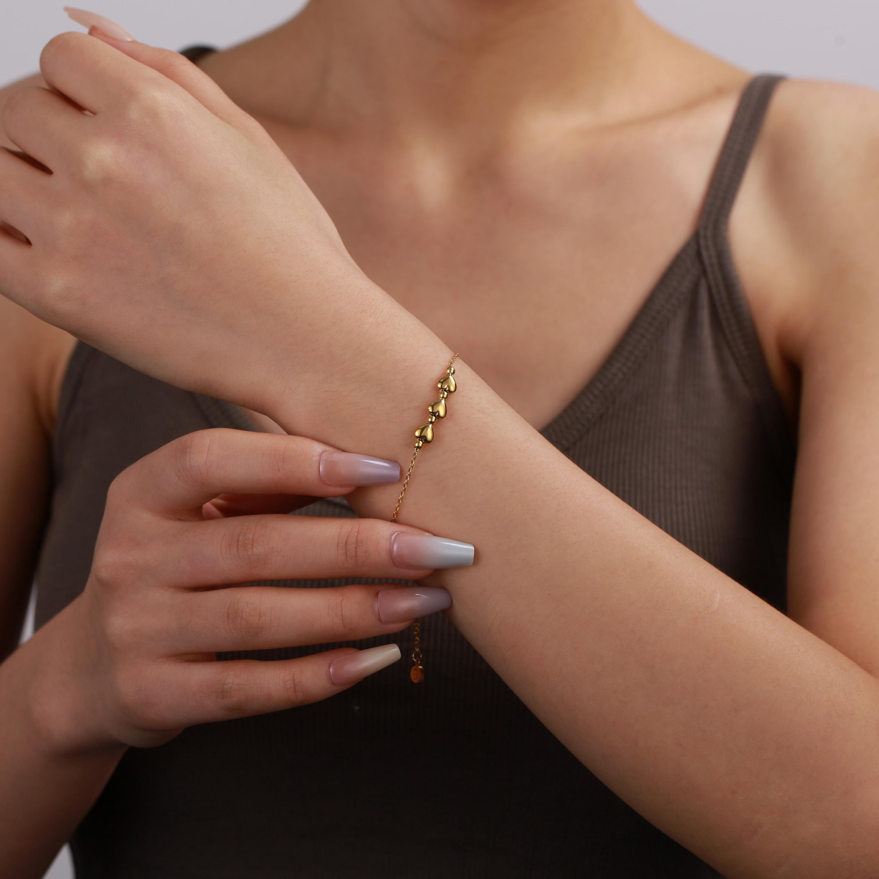 Gold-plated 3 heart bracelet on wrist, 16–20cm, Bijou Betty 30th birthday gift.