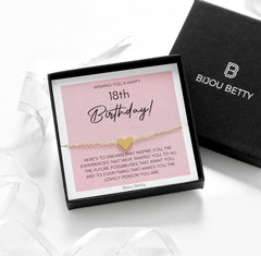 Close-up of gold-plated stainless steel heart bracelet, perfect for 18th birthday gifts for sisters.