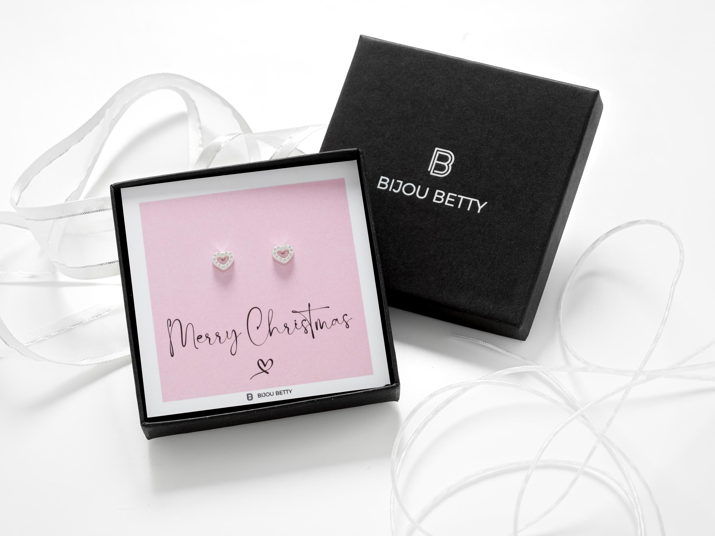 Close-up of rose gold-plated heart earrings, perfect for Secret Santa gifts for sisters.