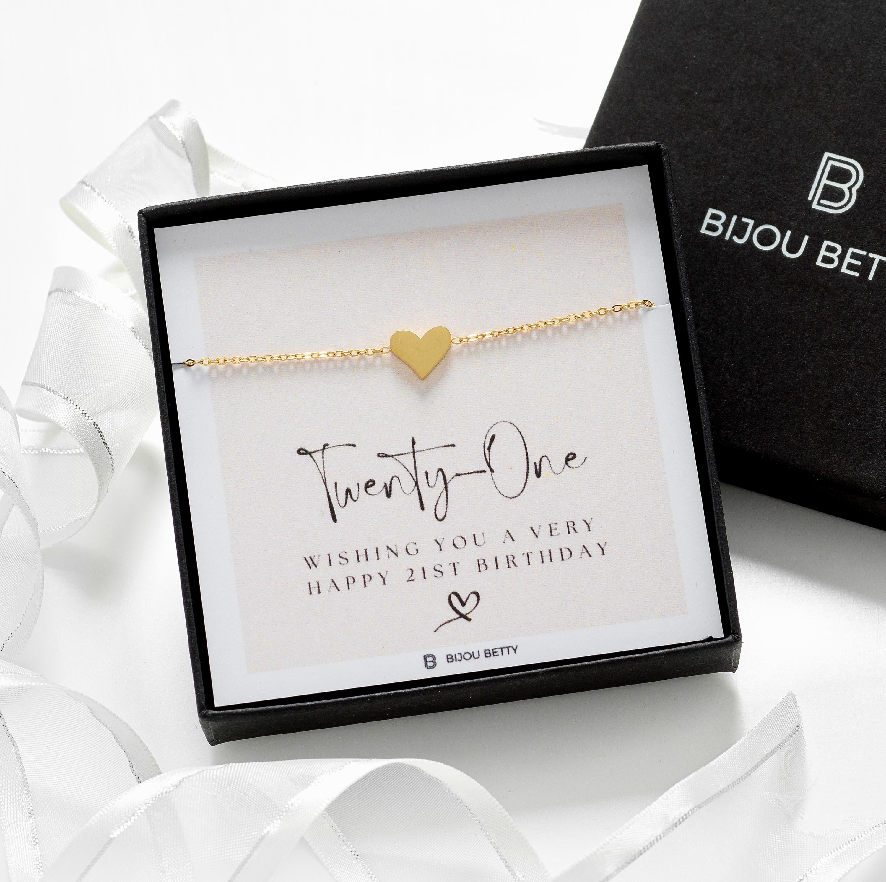 Close up of a mini heart gold plated bracelet with a gift box, perfect for daughters, friends and sisters.