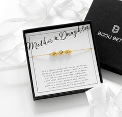 Close-up of gold-plated 3 heart bracelet, perfect for wedding day gifts for mothers or daughters.