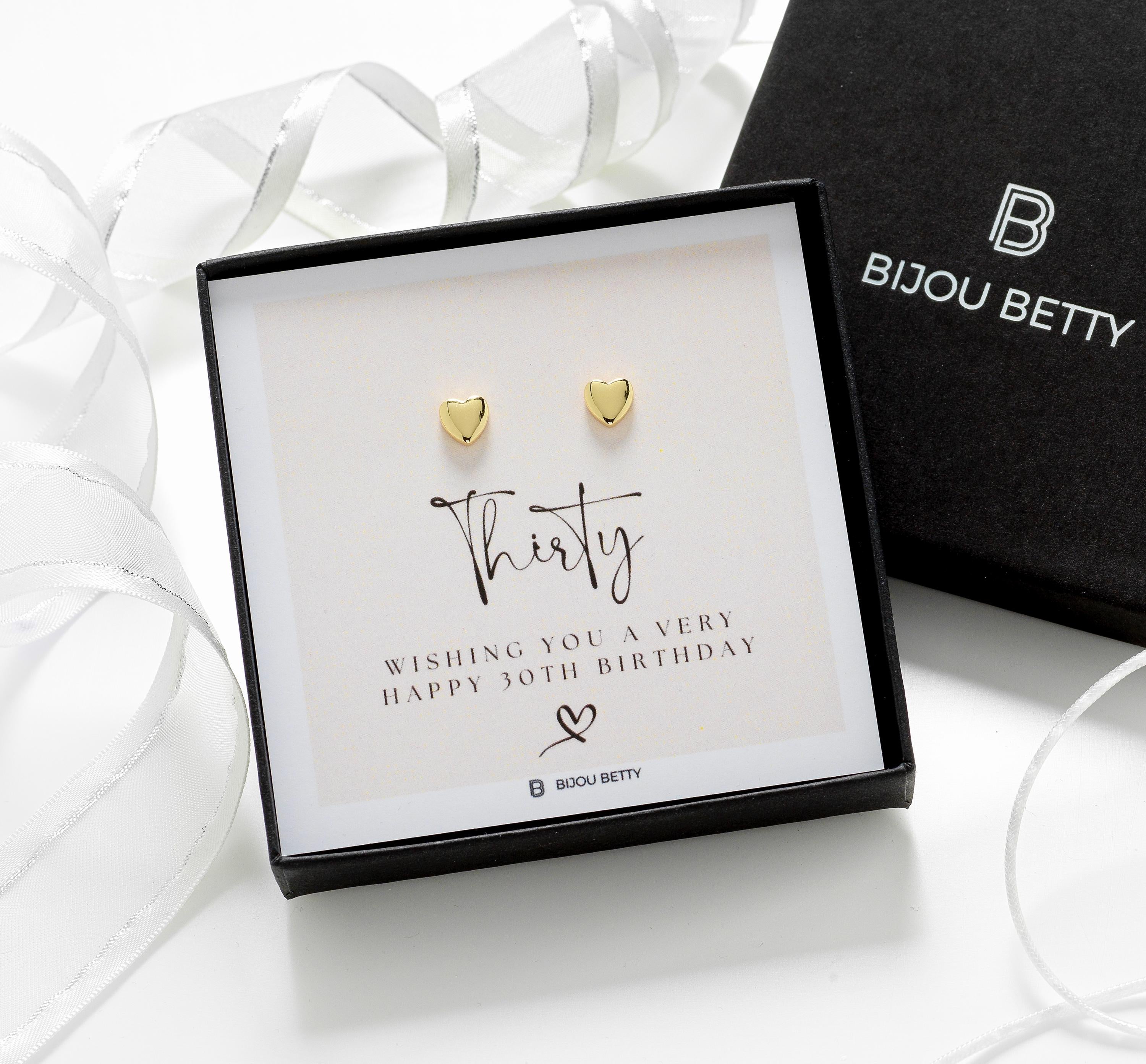 Close-up of gold-plated heart stud earrings, perfect for 30th birthday gifts for daughters.