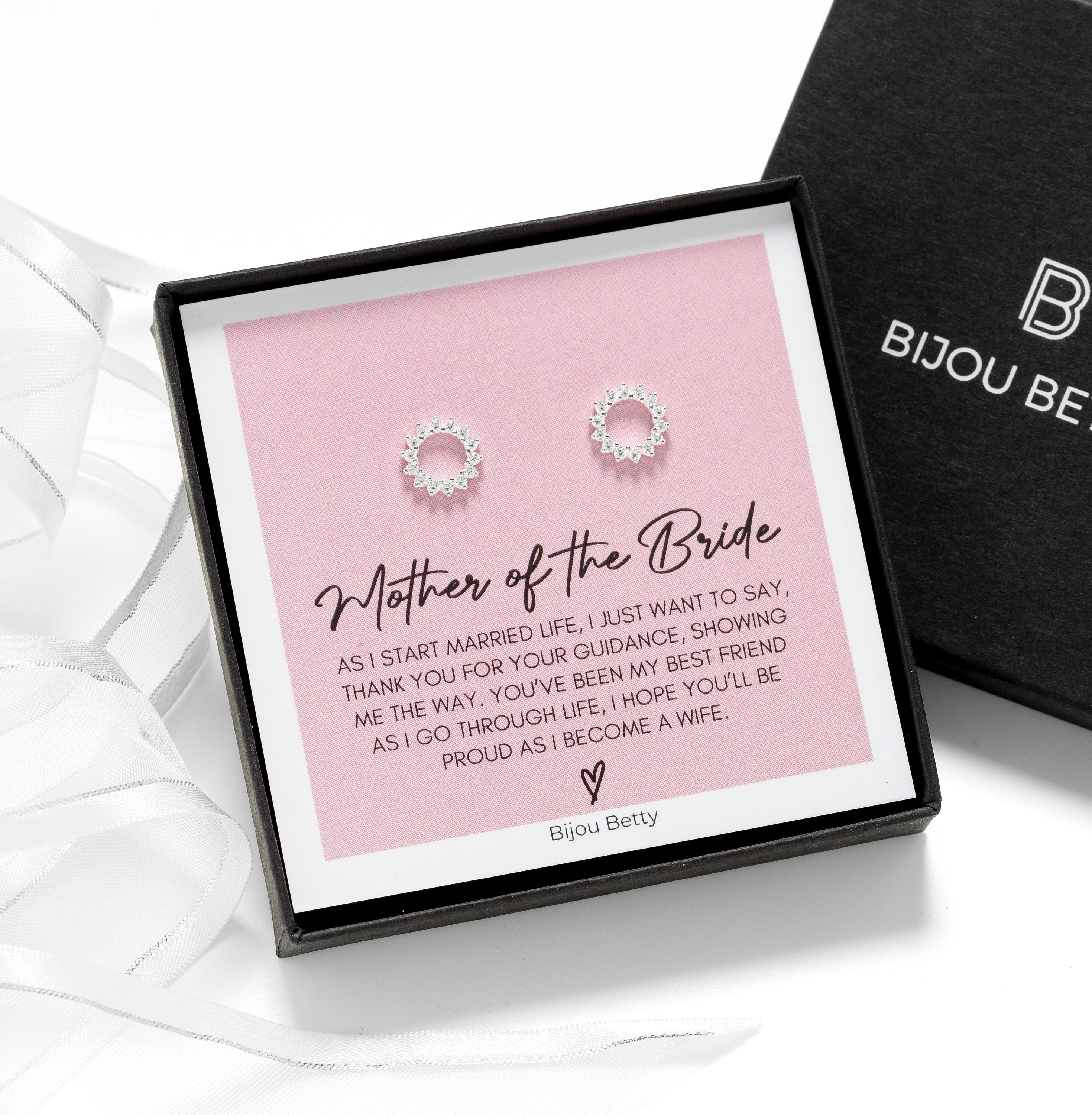 Close-up of 18k gold-plated sunburst earrings, perfect for mother of the bride thank-you gifts.