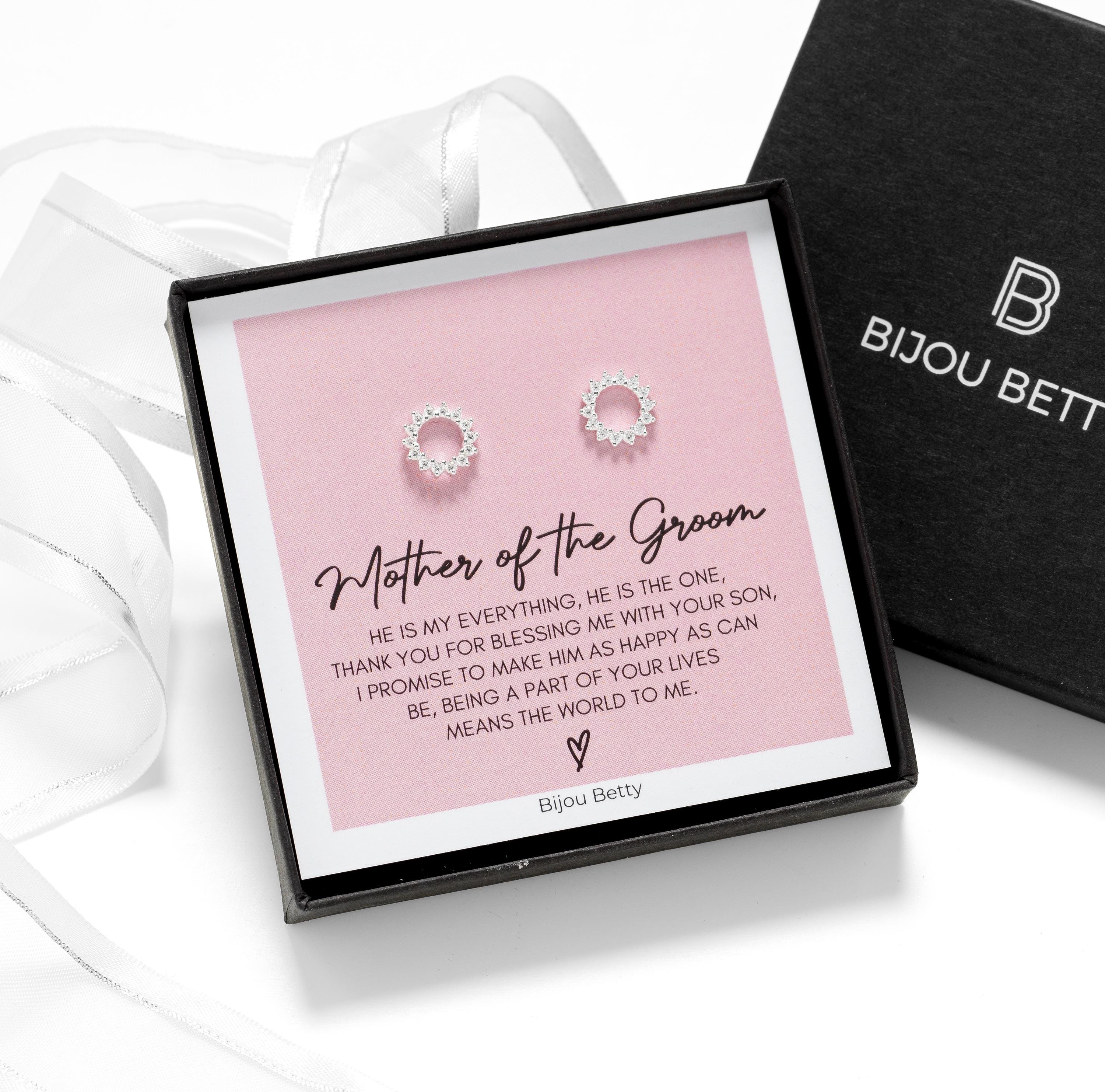 Close-up of 18k gold-plated sunburst earrings, perfect for mother of the groom thank-you gifts.