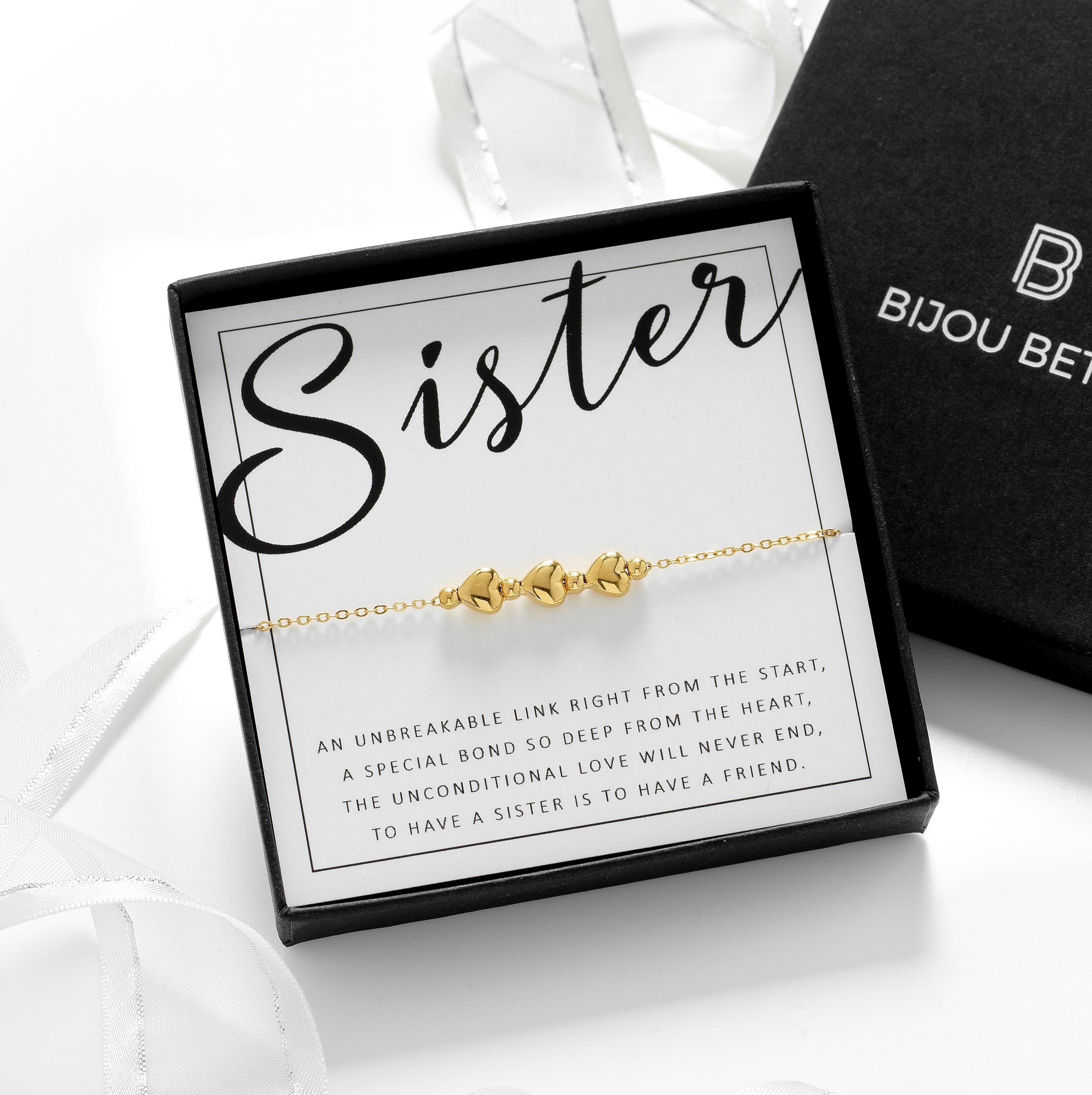 Close-up of a gold 3 heart bracelet, perfect for a little sister birthday gifts.