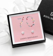 Close-up of silver heart earrings, perfect for 70th birthday gifts for mums or sisters.