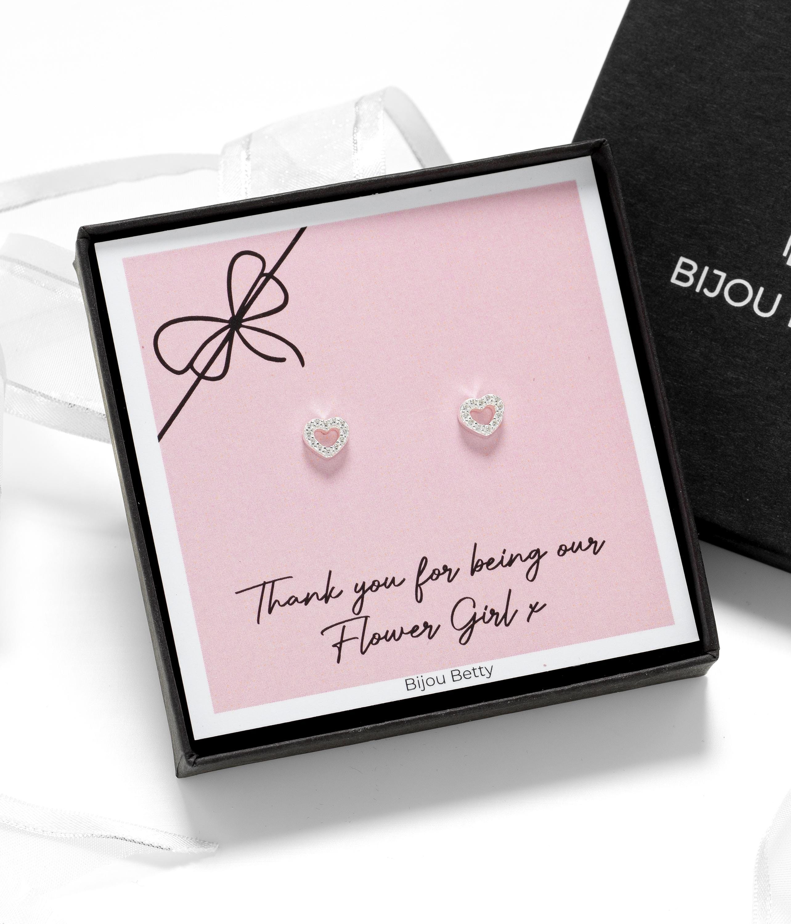 Close-up of rose gold-plated heart earrings, perfect for flower girl thank-you gifts.