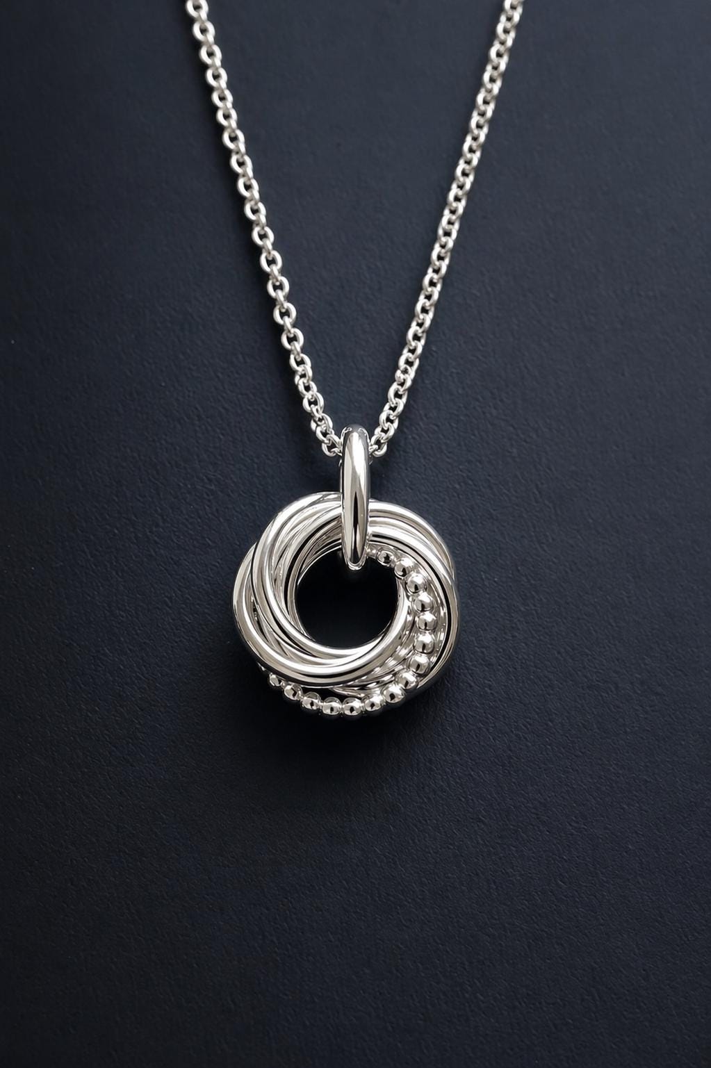 Silver 60th birthday necklace with 6 interlinked rings, each ring represents a decade.