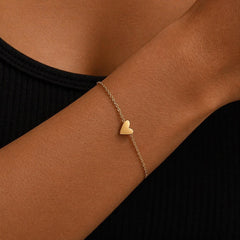 Small gold heart charm on an adjustable stainless steel bracelet