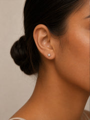 Dainty June birthstone pearl stone stud earrings worn.