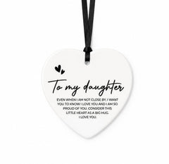 Heart-shaped ceramic plaque with a message to daughter on a white background